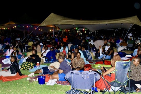 Crowd enjoying outdoor movie night