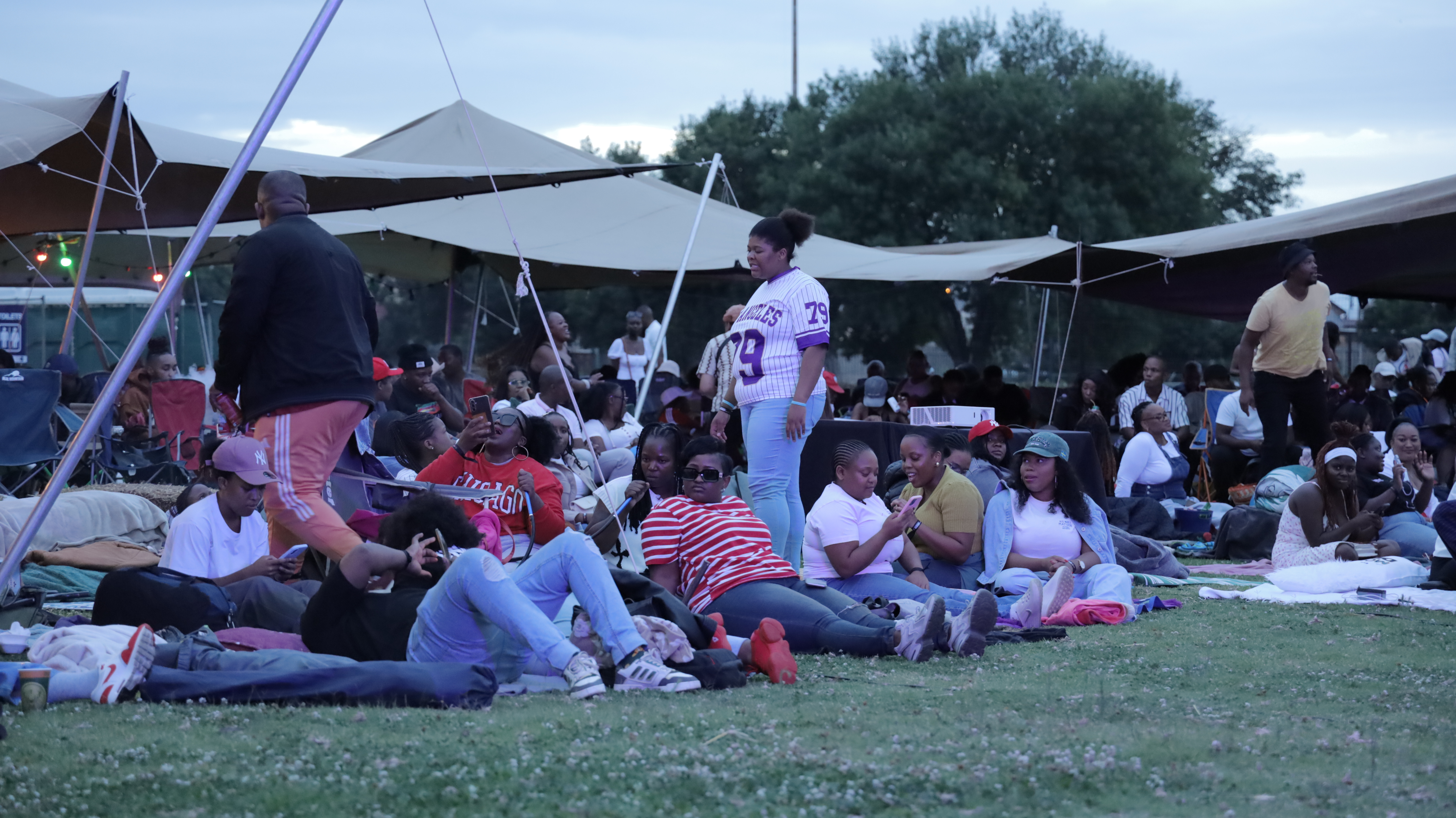 Crowd under string lights at OMN