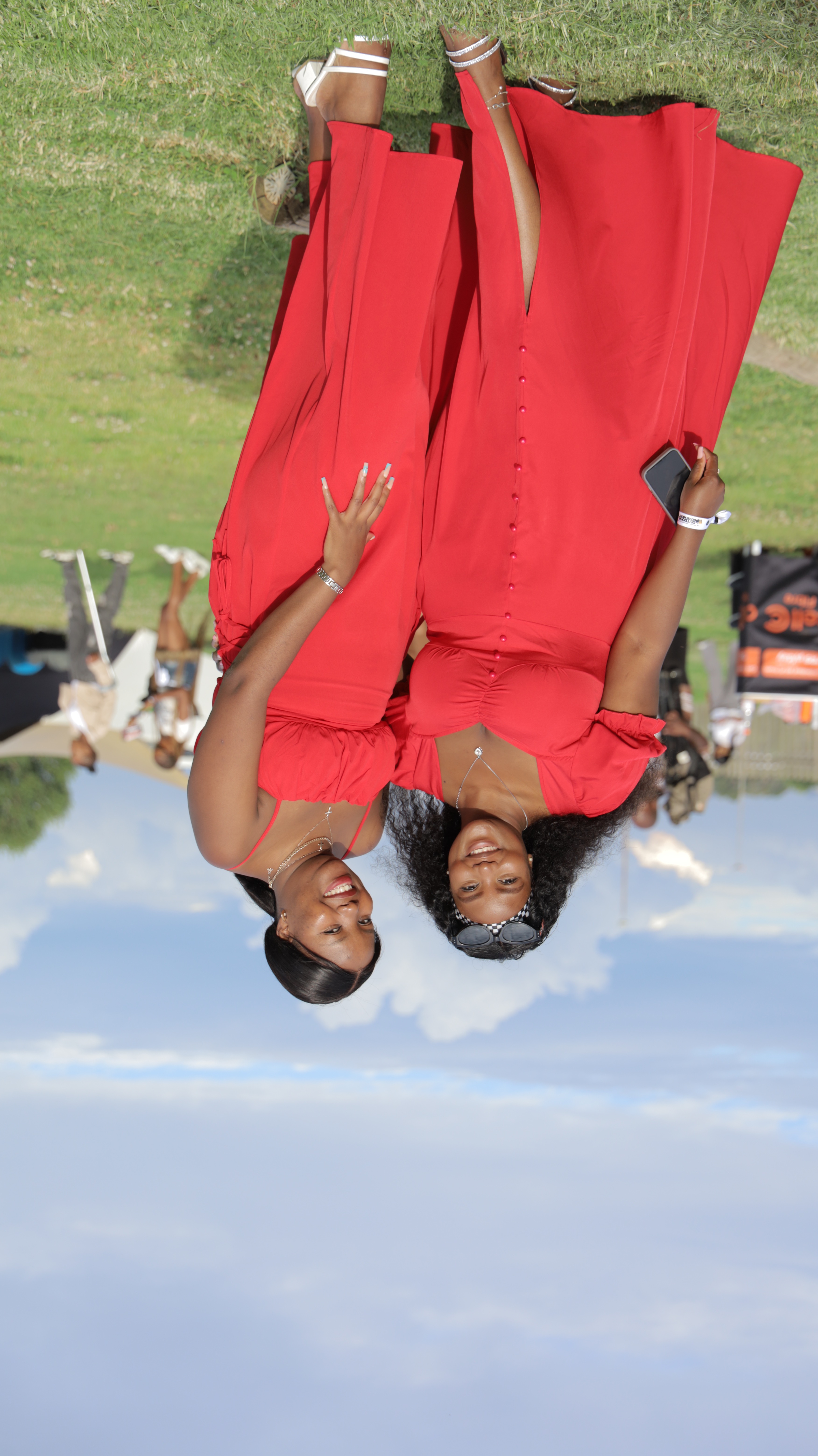 Attendees in red dresses at OMN event